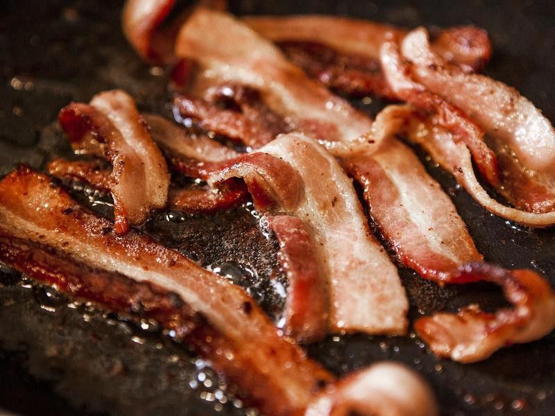 Sizzling bacon frying in a pan