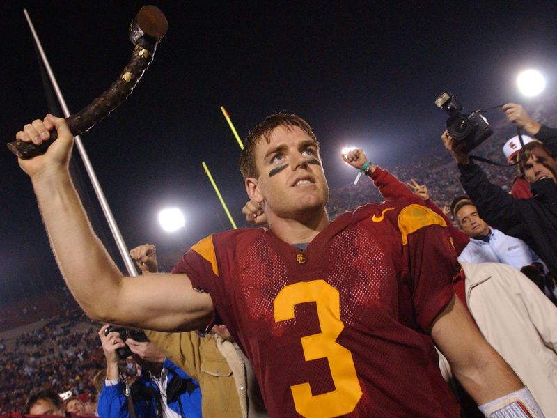 Southern California quarterback Carson Palmer holds up jeweled shillelagh to celebrate