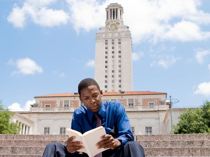Student reading on steps, Main Building, University of Texas, Austin