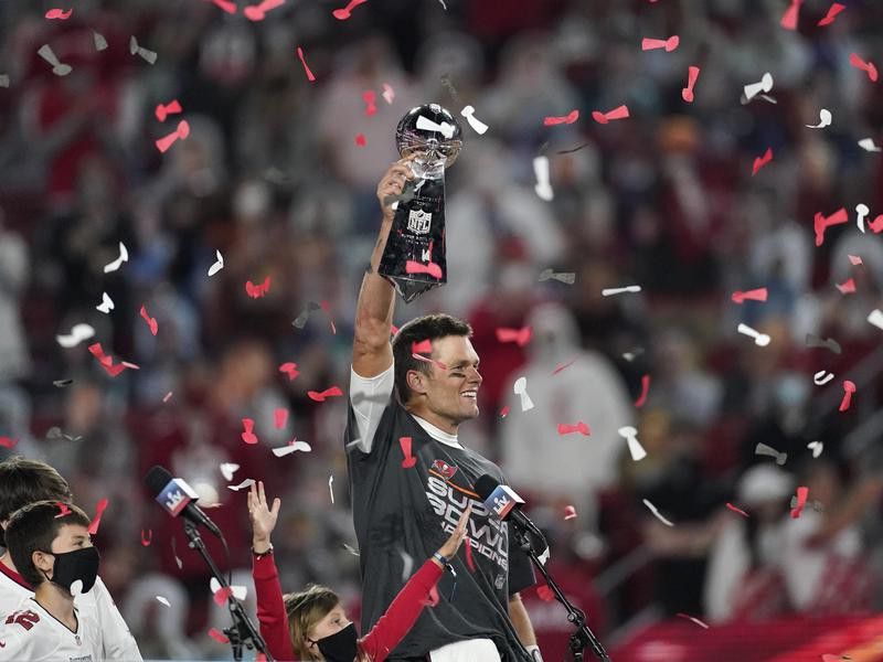 Tampa Bay Buccaneers quarterback Tom Brady holds up Vince Lombardi trophy