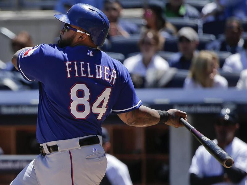 Texas Rangers designated hitter Prince Fielder follows through on base