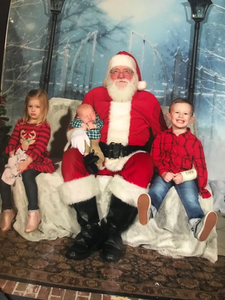 Three kids meeting Santa Claus