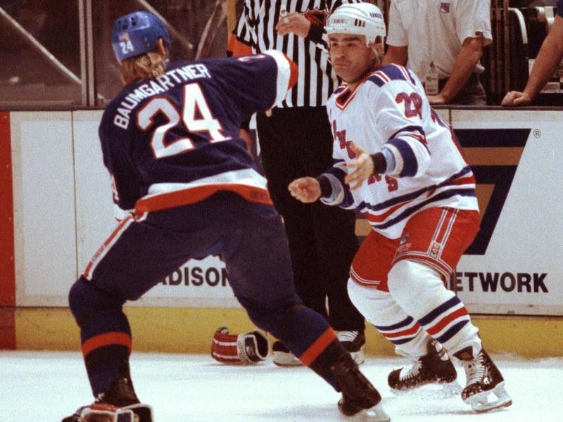 Tie Domi squares off with New York Islanders Ken Baumgartner during game at Madison Square Garden
