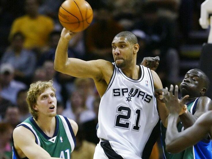 Tim Duncan looks to pass against Dirk Nowitzki and the Dallas Mavericks