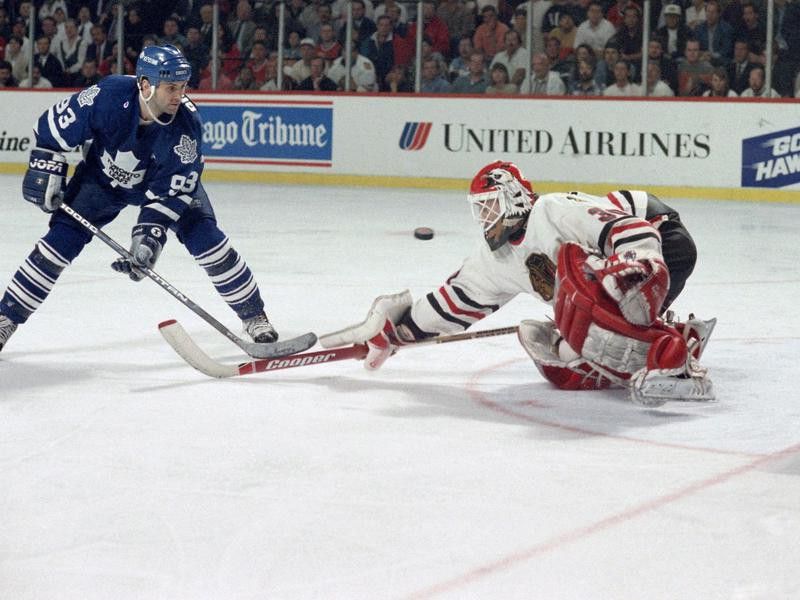 Toronto Blue Maple Leafs' Doug Gilmour watches as Chicago Blackhawks' Ed Belfour makes save