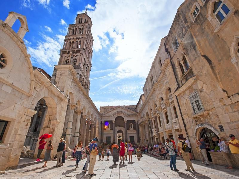 Tourist and locals walking on Peristil of Diocletian's palace