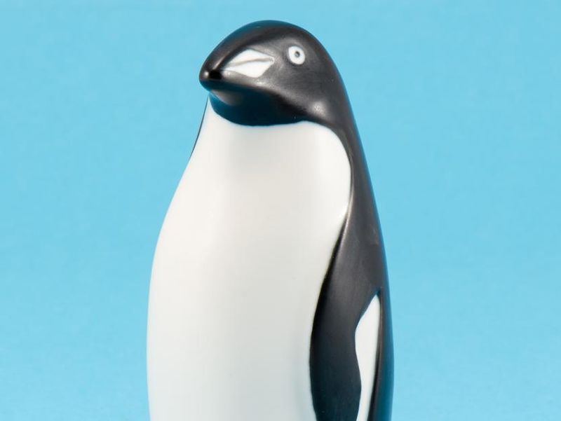 toy penguin figurine home decor on blue background