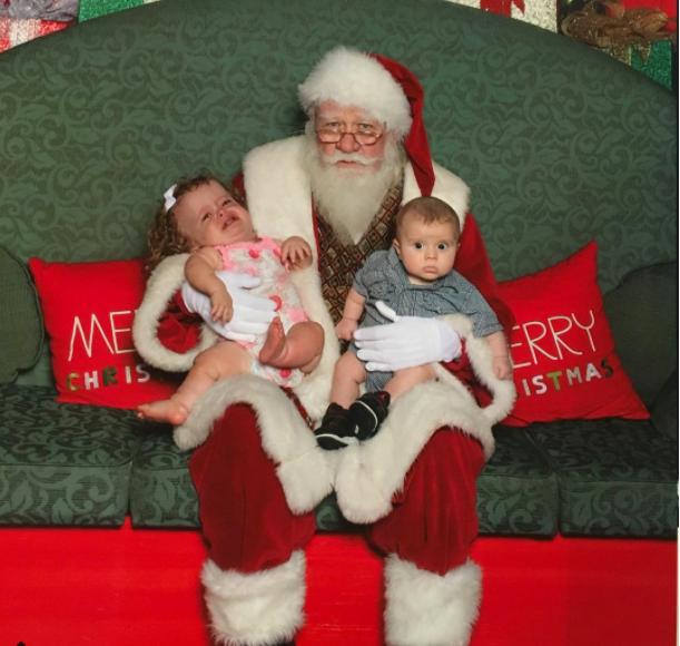 Two kids taking picture with Santa