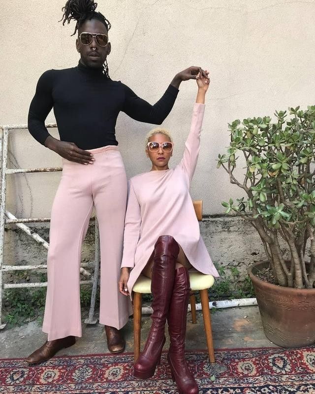 Two people posing in pink outfits