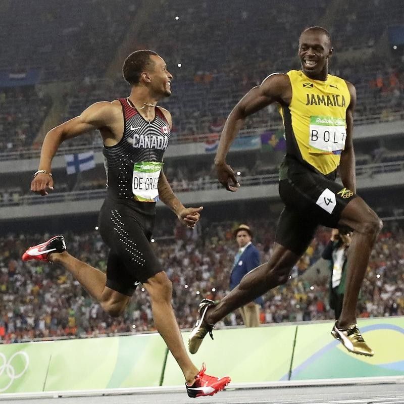 Usain Bolt of Jamaica and Andre De Grasse of Canada during 200-meter race in Rio
