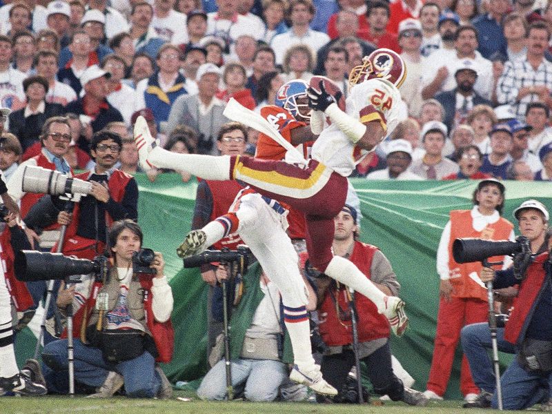 Washington Redskins Barry Wilburn intercepts pass by Denver Broncos John Elway
