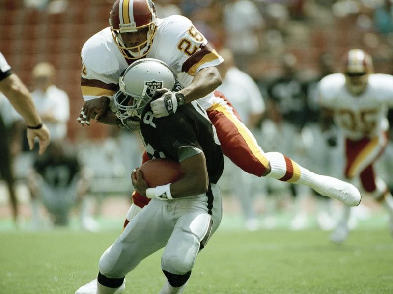 Washington Redskins Darrell Green is up and over Los Angeles Raiders Tim Brown