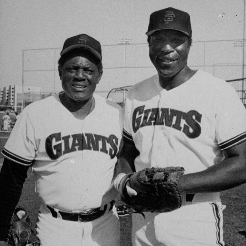 Willie Mays and Willie McCovey pose for a picture