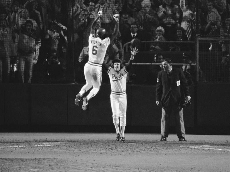 Willie Wilson leaps into the air to celebrate