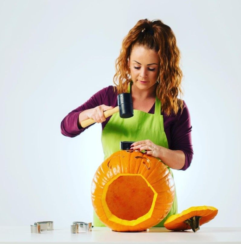 Woman carving a pumpkin with Pumpkin Punches