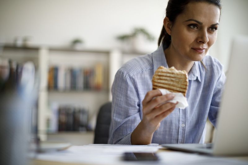 Woman eating and working
