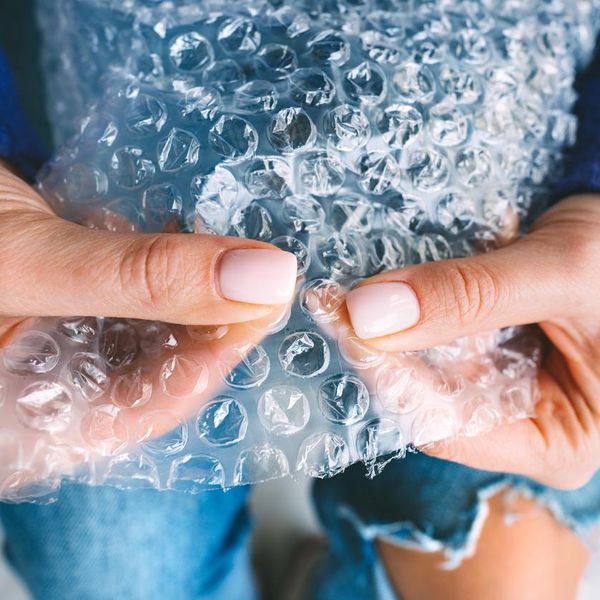 Woman hands squeezing or popping bubbles in bubble wrap. Anti stress, relax concept. High quality photo