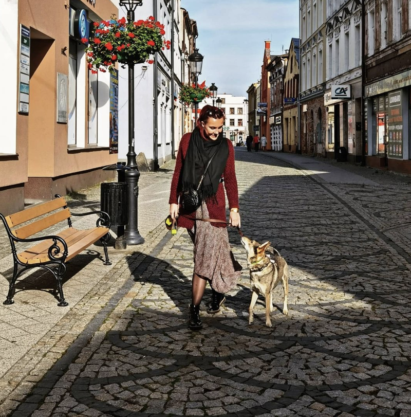 Woman in European city traveling with her dog