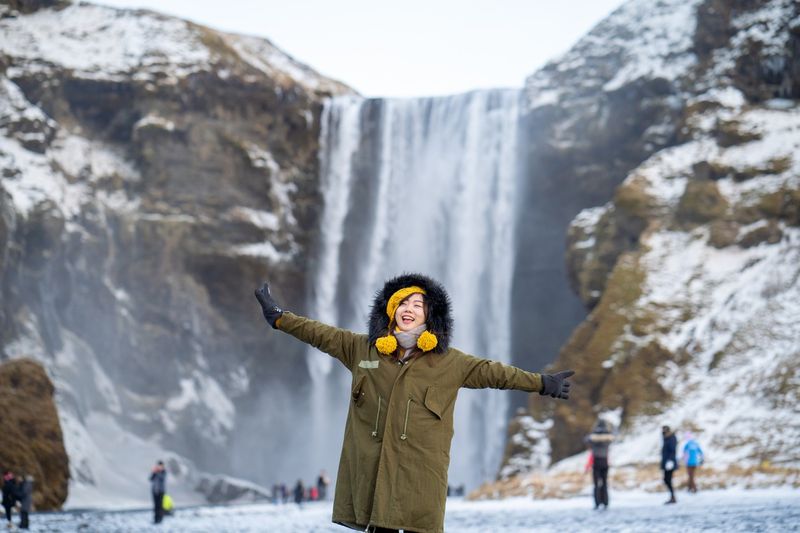 Woman in front of waterfall in iceland