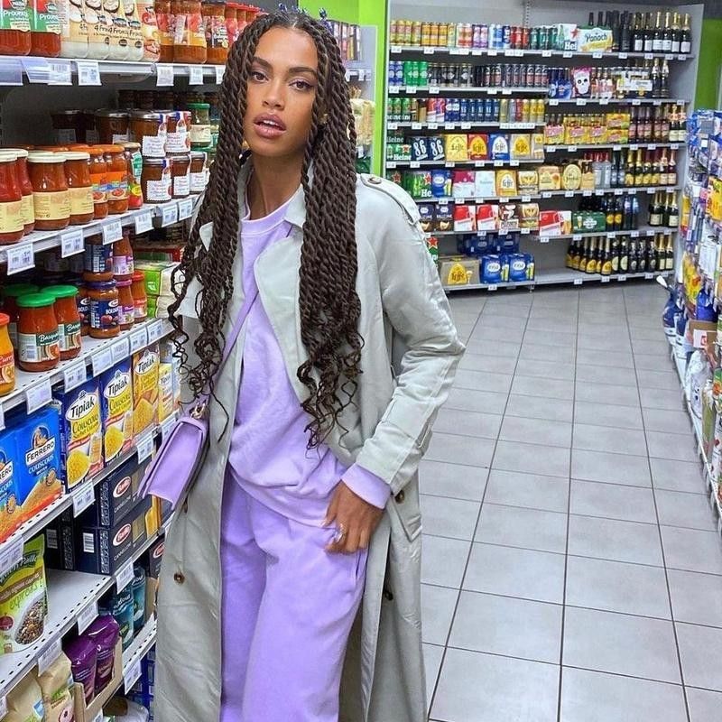 Woman poses in purple sweat suit