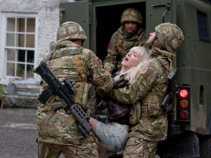 Woman restrained by soliders in How I Live Now