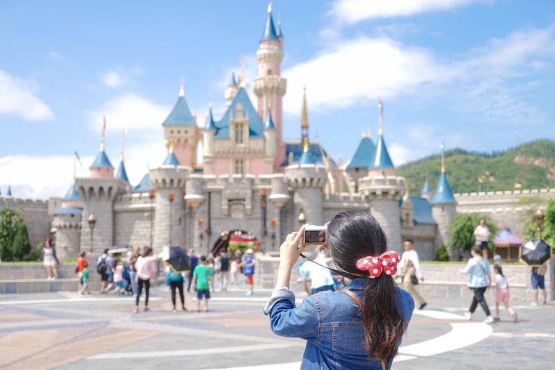 Woman taking pictures at Disney