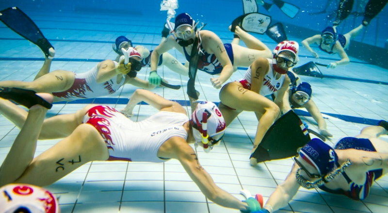 Women playing underwater hockey