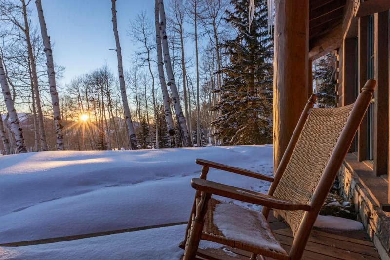 Wood rocking chair with a snow background