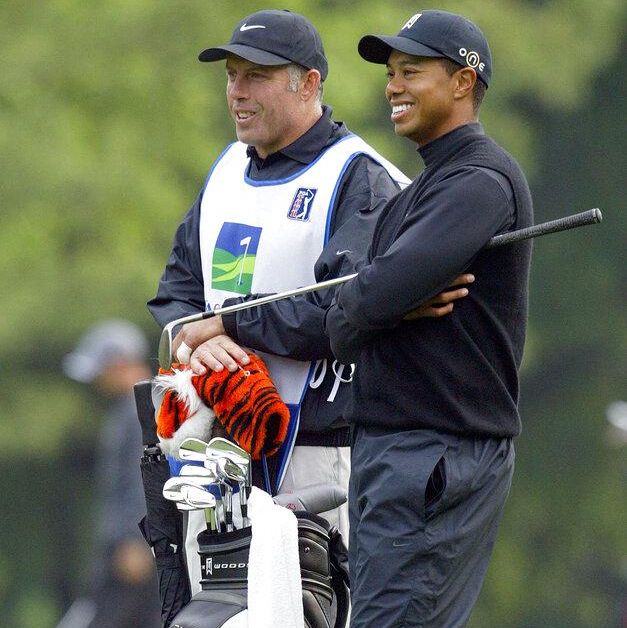 Woods laughing with caddie