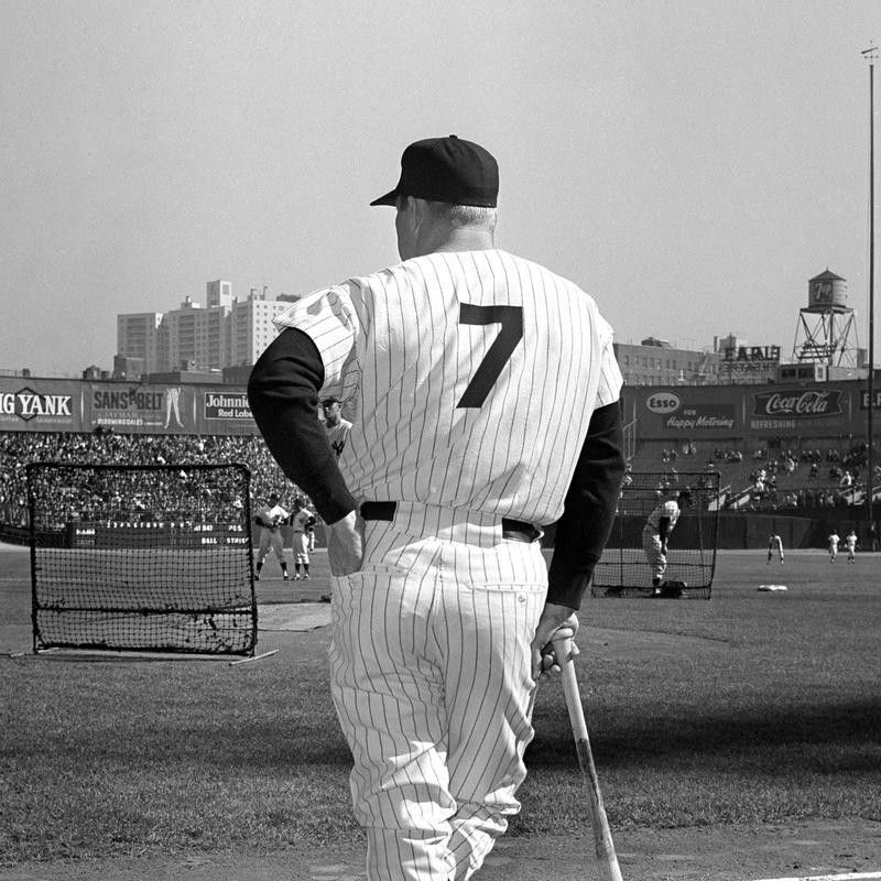 Yankee slugger Mickey Mantle leans on his bat