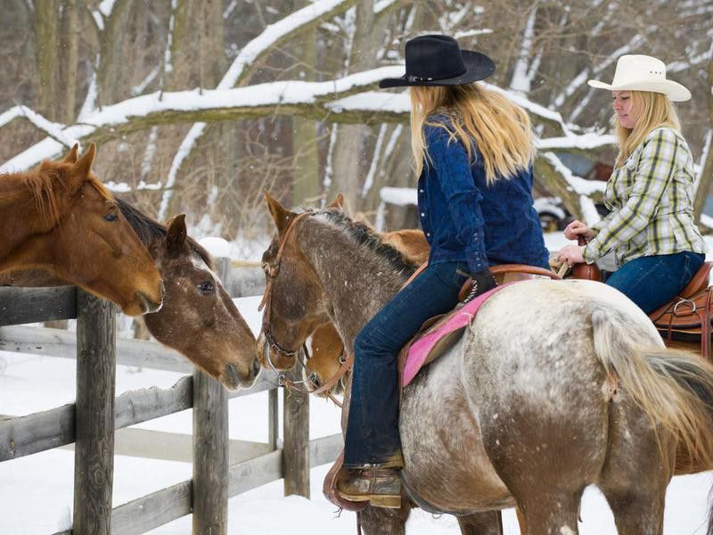 Young women on Appaloosa horses