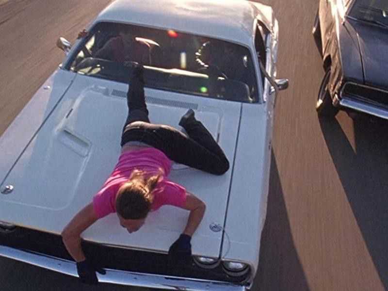 Zoe Bell Hanging Onto the Hood of a Car